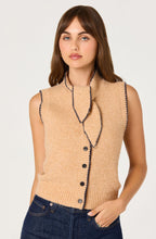 Load image into Gallery viewer, Woman wearing a beige sleeveless knitted ASTR cardigan with tie neck and buttons on a white background