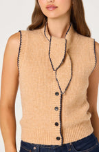 Load image into Gallery viewer, Woman wearing a beige sleeveless knitted ASTR cardigan with tie neck and buttons on a white background