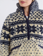 Load image into Gallery viewer, Close-up of a person wearing a patterned fleece pullover with a white background
