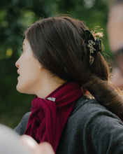 Load image into Gallery viewer, Woman with a red scarf and hair clip, blurred background