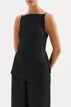 Load image into Gallery viewer, Black sleeveless top with layered design worn by a person on a white background